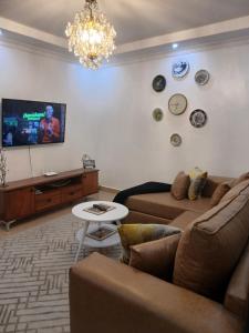 a living room with a couch and a tv at The Bird House in Munyu