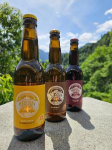 three bottles of beer sitting on a table at Gasthaus Rössli in Versam
