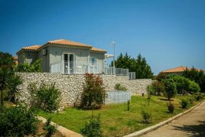 a house on top of a stone wall at Villas LaVista in Skala
