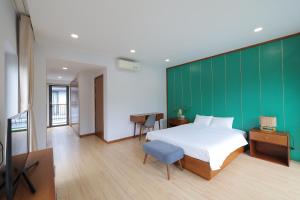 a bedroom with a bed and a green wall at MT Luxury Villas Phu Quoc in Phú Quốc +45 photos