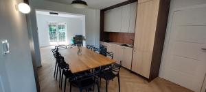 a dining room with a wooden table and chairs at Zaczarowany Bieślin in Trzemeszno