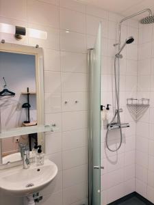 a bathroom with a sink and a shower at Hotel Falun in Falun +53 photos