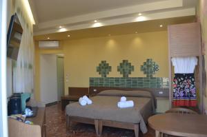 a bedroom with two beds with towels on them at Adua Rooms - Tropea Center in Tropea