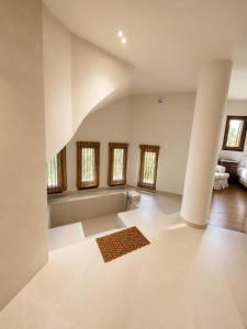 a large room with white walls and floors and windows at Sea & Salt ,Pelion,Agria Volos in Agria