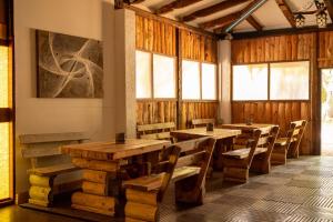 a restaurant with wooden tables and chairs and windows at Bikers camp in Poreč