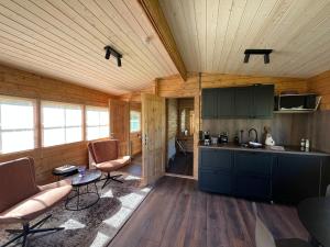 a kitchen and living room in a log cabin at Jökla Guesthouse in Skjöldólfsstaðir