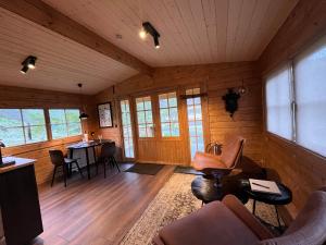 a living room with wood paneling and a table and chairs at Jökla Guesthouse in Skjöldólfsstaðir