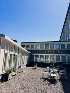 a building with chairs and tables in a courtyard at Hotel Falun in Falun