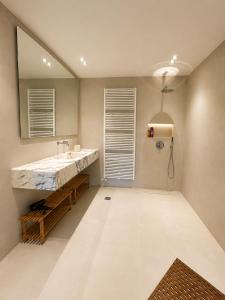 a bathroom with a large sink and a shower at Sea & Salt ,Pelion,Agria Volos in Agria
