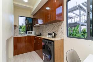 a kitchen with a washer and dryer in a house at White Sand Maldives in Ukulhas
