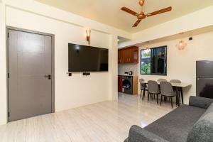 a living room with a couch and a flat screen tv at White Sand Maldives in Ukulhas