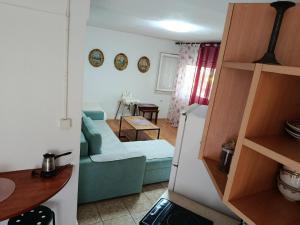 a living room with a blue couch and a table at Vila Katerina Dojran in Sretenovo