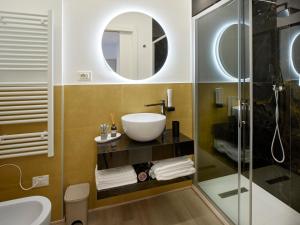 a bathroom with a sink and a glass shower at Palazzo house in Palazzo +18 photos