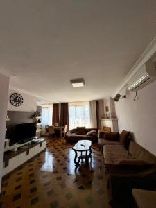 a living room with a couch and a table at Qobuleti, Rustaveli street 162 e in Itʼkhvisi