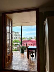 a view of a patio with a table and chairs at Qobuleti, Rustaveli street 162 e in Itʼkhvisi