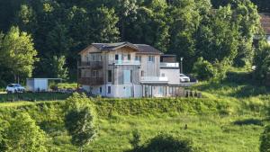 a house on a hill in a field at Morgenrot Panorama Apartment 1 - Terrasse in Gnotzheim