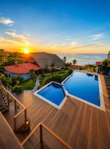 a swimming pool on a deck with a view of the ocean at Laola Surf Residence in El Sunzal +20 photos