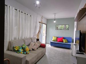 a living room with a couch with pillows on it at Temporada Belas Casas in São Pedro
