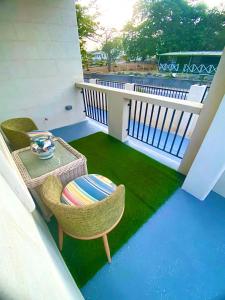 a balcony with a table and chairs on a balcony at Jadens Guest House - by ZenBreak in Saint Michael