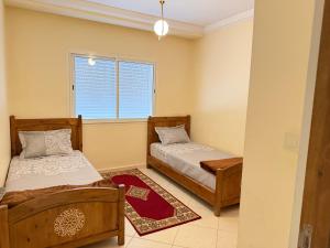 a bedroom with two beds and a window at Assafa in Agadir