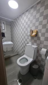 a bathroom with a toilet and a sink at The Suite in Kavála +11 photos