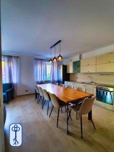a kitchen and dining room with a wooden table and chairs at Casa Vacanze Antico Eremo, tra natura e tradizione in Campodenno +27 photos