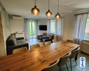 a living room with a large wooden table and chairs at Casa Vacanze Antico Eremo, tra natura e tradizione in Campodenno