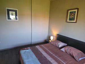 a bedroom with a bed and two pictures on the wall at Petra in Poreč