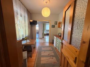a hallway with a kitchen with a table and a desk at Spokojna Zagroda in Biały Dunajec