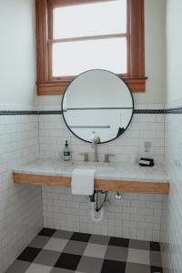 a bathroom with a mirror and a sink at The Mansard House in Galveston +9 photos