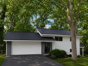 a house with a black roof and a garage at Modern 3BR With Big Kitchen & TV Rm in State College
