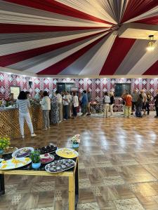 a group of people standing in a tent with food at SaLem rum in Wadi Rum