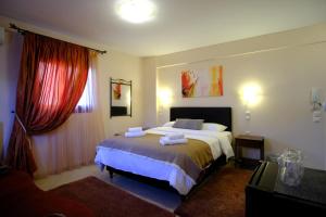 a bedroom with a bed with two towels on it at Anesis in Ioannina