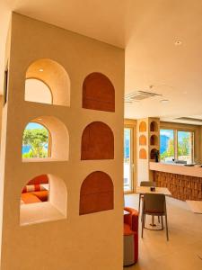 a room with a wall with arches in it at Beach Hotel Terracotta in Sapri