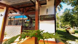 a building with a sign that reads the entrance to a restaurant at Güembé Hotel Lodge & Resort in Santa Cruz de la Sierra