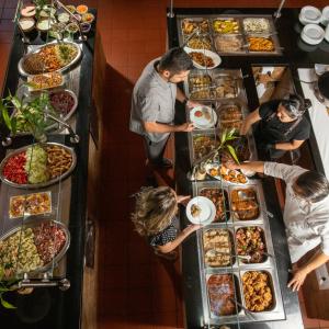 a group of people preparing food at a buffet at Güembé Hotel Lodge & Resort in Santa Cruz de la Sierra