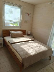 a bedroom with a large bed with a window at Morgenrot Panorama-Apartment 2 - Zwei Balkone in Gnotzheim