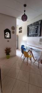 a living room with a table and chairs at Apprt Ennakhil 2 in El Jadida