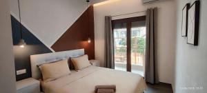 a bedroom with a white bed and a window at Theasis 2 in Neos Marmaras