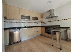 a large kitchen with a table and a stove at Check-in casas Mesón Casa Cereza in El Run +9 photos