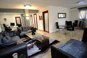 a living room with couches and a dining room at Anesis in Ioannina