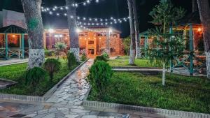 a garden in front of a building with lights at Villa MD Grigoleti in Grigoleti