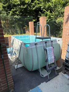 a small swimming pool with a chair next to it at BnB Dog and Friend in Rocchetta Tanaro