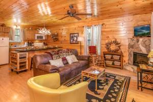 a living room with a couch and a fireplace at Romantic Smoky Mtn Cabin Private Hot Tub Quiet Wooded Retreat in Sevierville