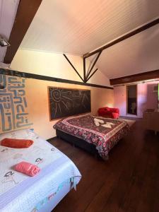 a bedroom with two beds in a room at Hotel da Vila in Nova Friburgo