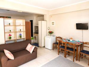 a living room with a couch and a table at Nefeli’s guest house in Nydri