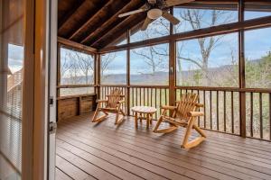 a screened in porch with chairs and a ceiling fan at Breathtaking Views No-Stair Entry, Hot Tub, Pool Table & Seasonal Pool Access in Sevierville