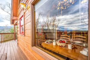 a balcony with a window with a view of the mountains at Breathtaking Views No-Stair Entry, Hot Tub, Pool Table & Seasonal Pool Access in Sevierville