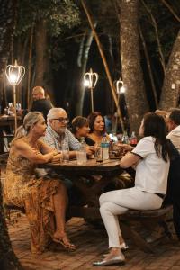 a group of people sitting at a picnic table at Güembé Hotel Lodge & Resort in Santa Cruz de la Sierra +7 photos