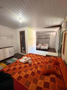 a bedroom with a bed with a checkered floor at Hotel da Vila in Nova Friburgo